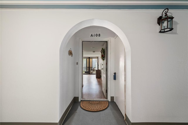 hallway with hardwood / wood-style floors