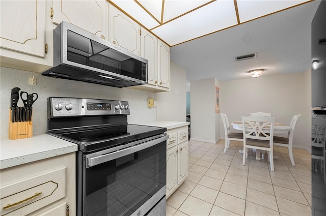 kitchen featuring light tile patterned floors and appliances with stainless steel finishes