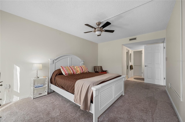 carpeted bedroom with a textured ceiling and ceiling fan