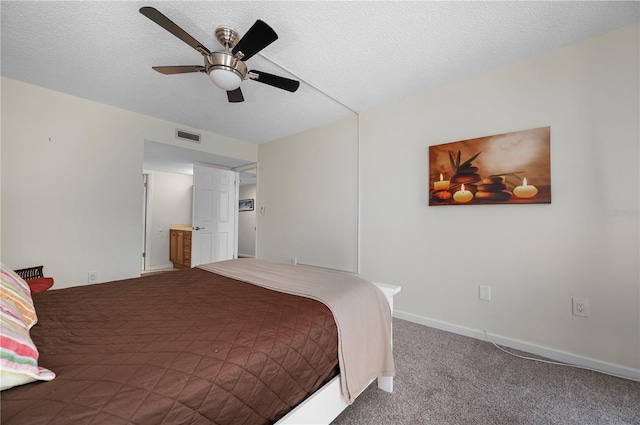 carpeted bedroom with ceiling fan and a textured ceiling