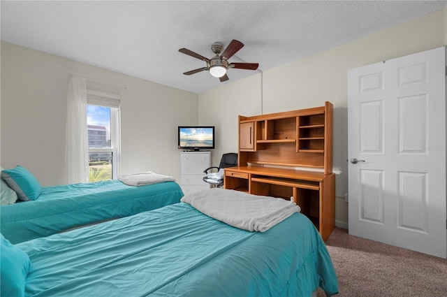 carpeted bedroom with ceiling fan and a textured ceiling