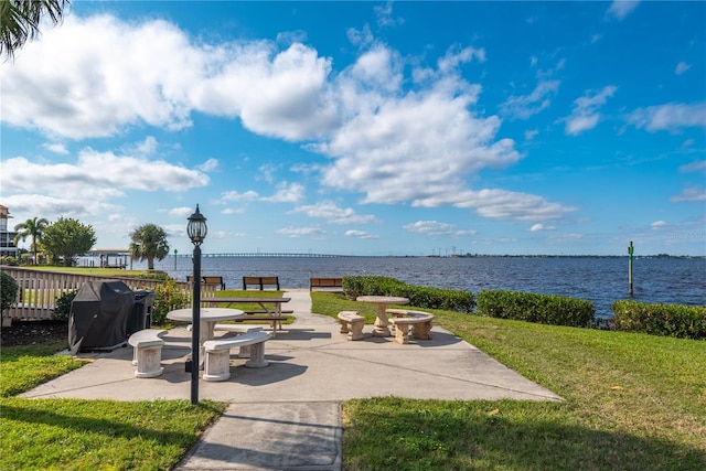 view of patio featuring a grill and a water view