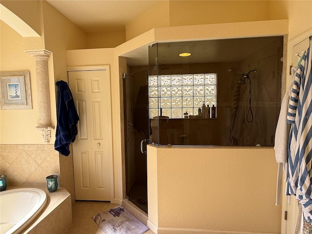 bathroom featuring tile patterned floors and separate shower and tub