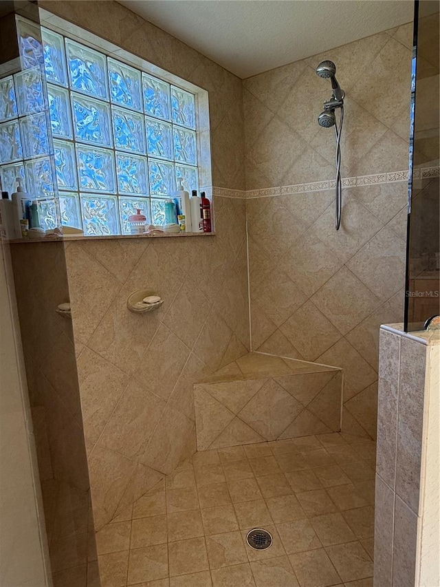 bathroom with tiled shower