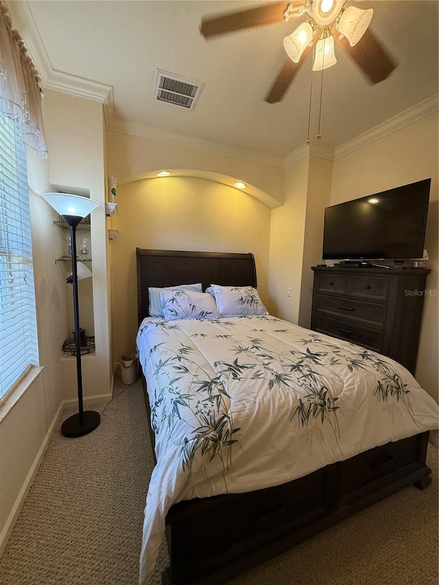 carpeted bedroom featuring ceiling fan and ornamental molding