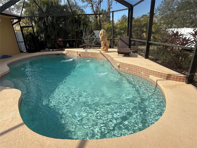 view of pool featuring pool water feature, a lanai, and a patio area