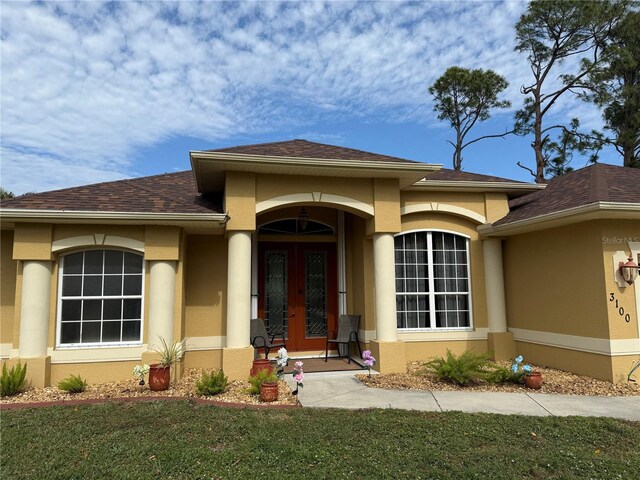 view of exterior entry featuring french doors