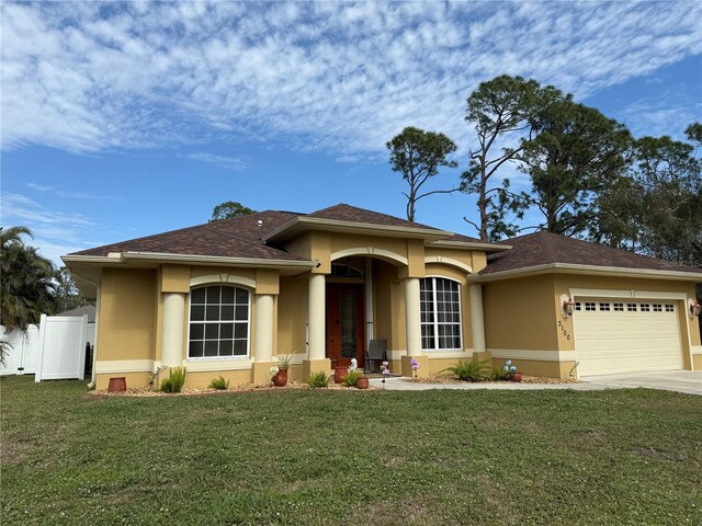 prairie-style house featuring a garage and a front yard