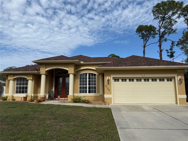 view of front facade with a garage and a front lawn