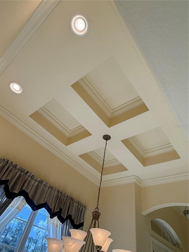 interior details with beam ceiling, ornamental molding, and coffered ceiling