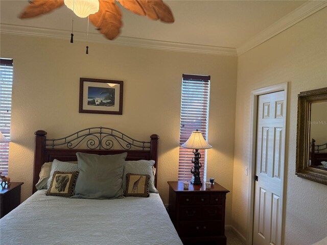 bedroom featuring ceiling fan and ornamental molding