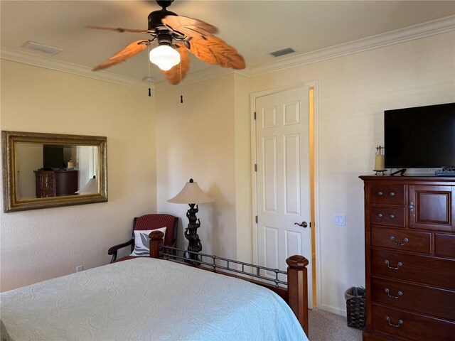 bedroom with carpet floors, ceiling fan, and crown molding