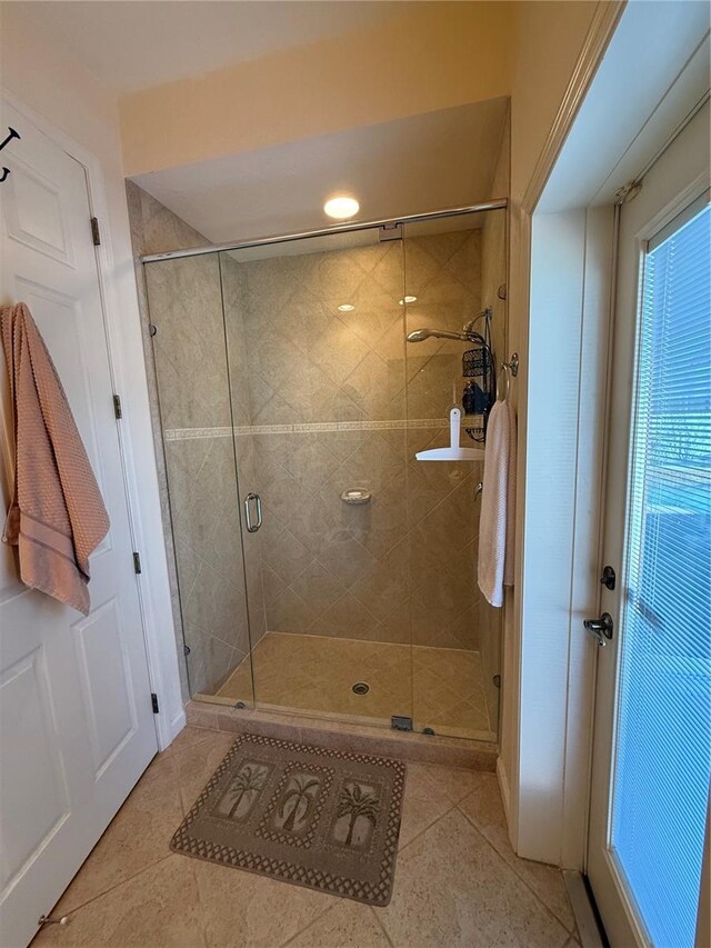 bathroom featuring tile patterned floors and an enclosed shower