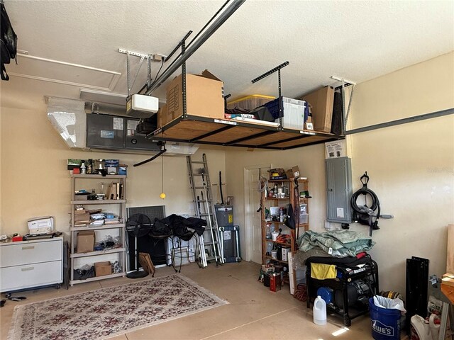 garage with electric panel and a garage door opener