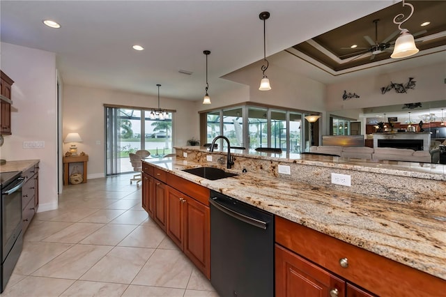 kitchen with pendant lighting, black appliances, sink, ceiling fan, and light stone counters