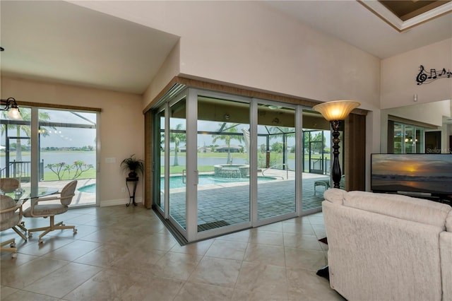 doorway featuring a water view and light tile patterned floors