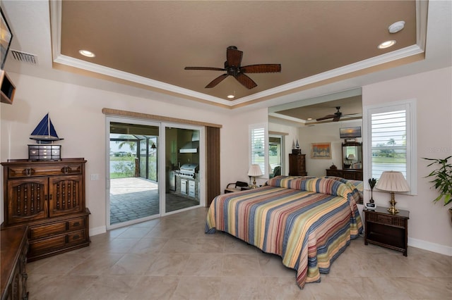 bedroom featuring ceiling fan, a tray ceiling, access to outside, and multiple windows