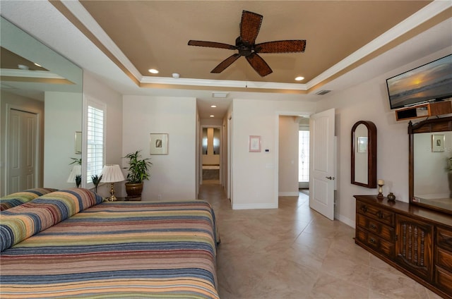 bedroom featuring ceiling fan and a tray ceiling