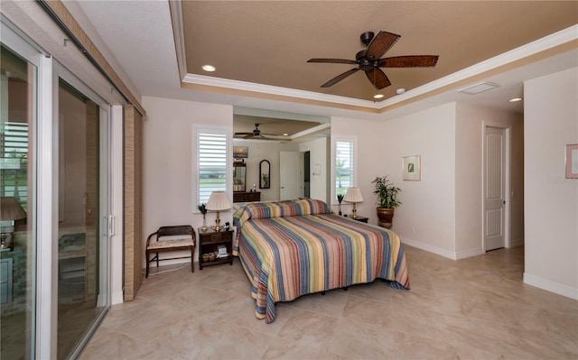 bedroom with a tray ceiling, multiple windows, ornamental molding, and ceiling fan