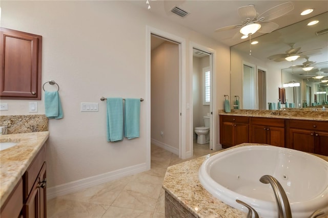 bathroom with vanity, ceiling fan, toilet, and tiled bath