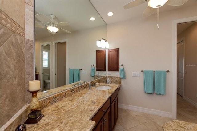 bathroom with vanity, toilet, and ceiling fan