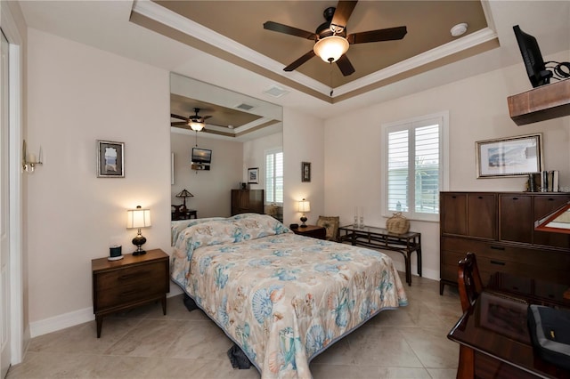 bedroom featuring ceiling fan, crown molding, and a tray ceiling