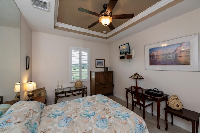 bedroom featuring ceiling fan, crown molding, and a tray ceiling