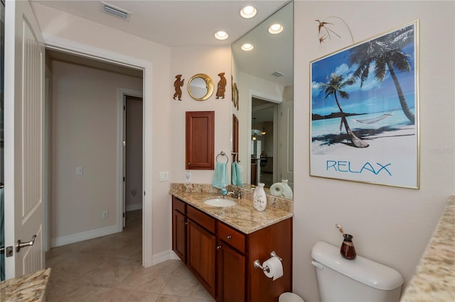 bathroom featuring tile patterned floors, vanity, and toilet