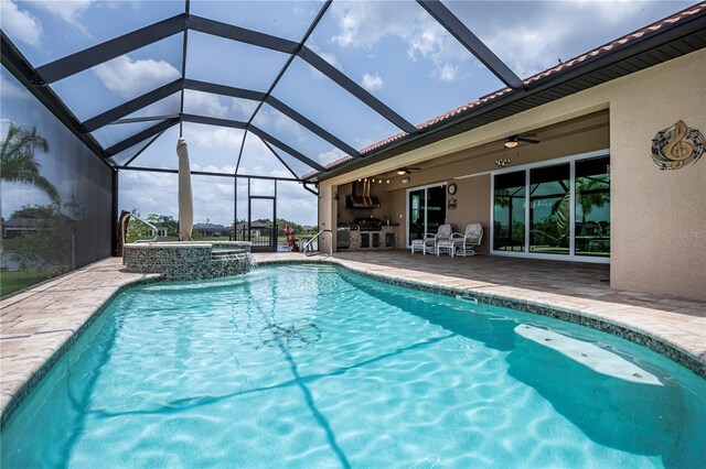 view of pool featuring a patio, ceiling fan, an in ground hot tub, and glass enclosure