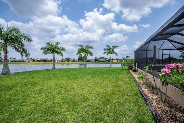 view of yard featuring a water view and a lanai