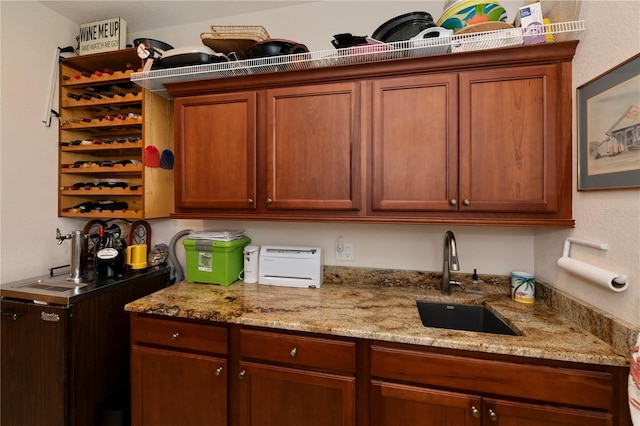 kitchen with light stone countertops and sink