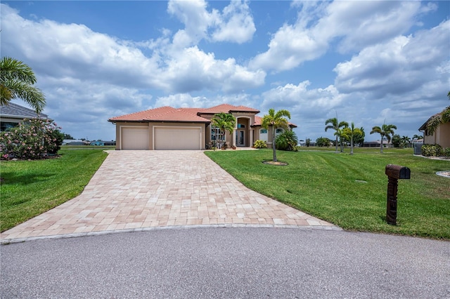 view of front of home with a garage and a front yard