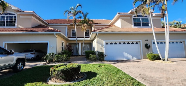 view of front of home with a garage and a front lawn