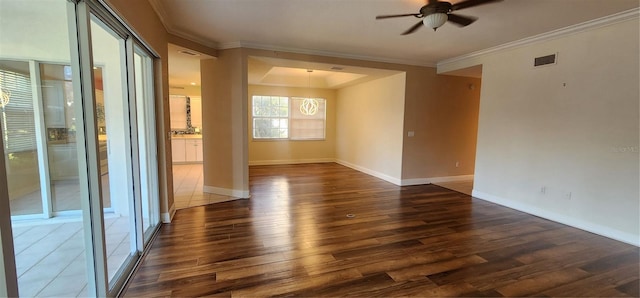 unfurnished room with ceiling fan, dark hardwood / wood-style flooring, and ornamental molding