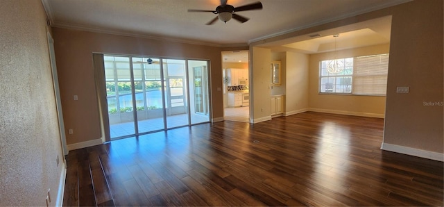 spare room featuring dark hardwood / wood-style floors, ceiling fan, and crown molding