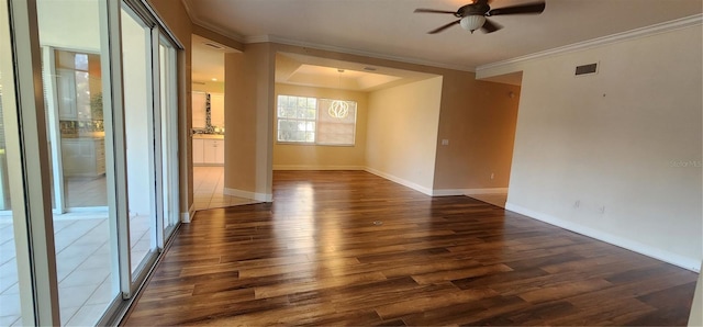 unfurnished room with ceiling fan, dark wood-type flooring, and ornamental molding