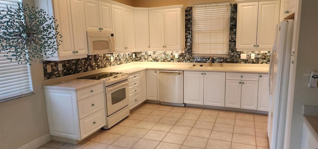 kitchen featuring white cabinets, white appliances, and sink