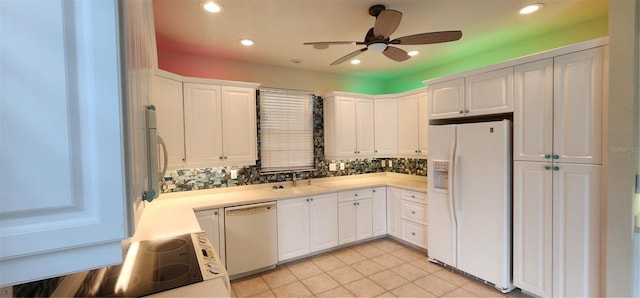 kitchen featuring white appliances, white cabinets, ceiling fan, light tile patterned floors, and tasteful backsplash