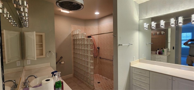 bathroom with tile patterned floors, a shower, and vanity