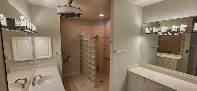 bathroom featuring a tile shower, tile patterned floors, and vanity