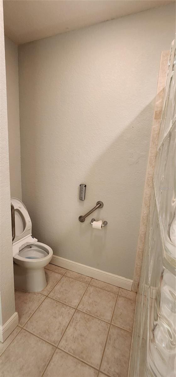 bathroom featuring tile patterned flooring and toilet