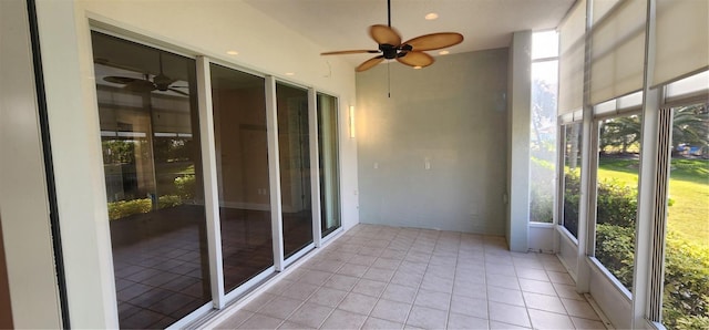 unfurnished sunroom featuring ceiling fan