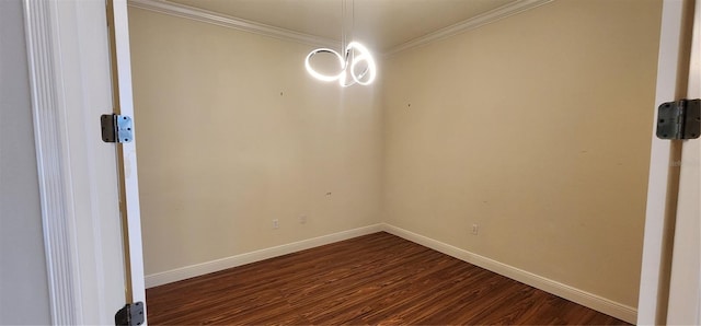 empty room with dark hardwood / wood-style flooring and ornamental molding