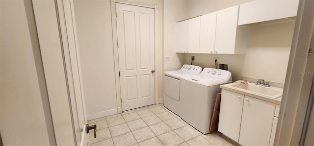 washroom with washer and dryer, cabinets, light tile patterned floors, and sink