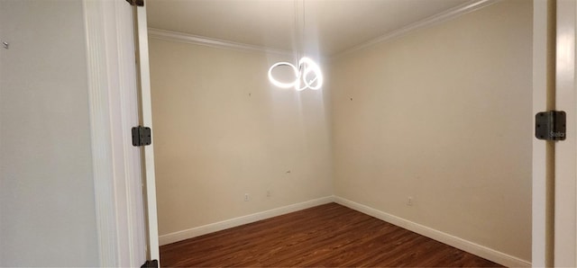 spare room with crown molding and dark wood-type flooring