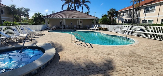 view of pool featuring a community hot tub and a patio area