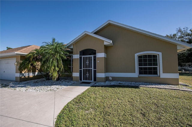 ranch-style home with a garage and a front lawn