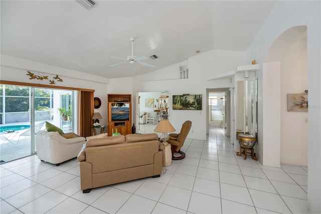 living room featuring vaulted ceiling, ceiling fan, and light tile patterned flooring