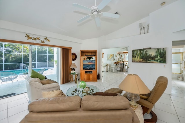 tiled living room with ceiling fan and vaulted ceiling