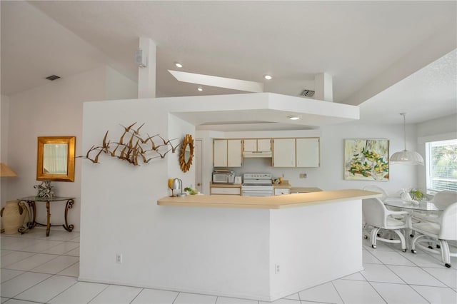 kitchen featuring light tile patterned floors, white appliances, decorative light fixtures, and lofted ceiling with skylight